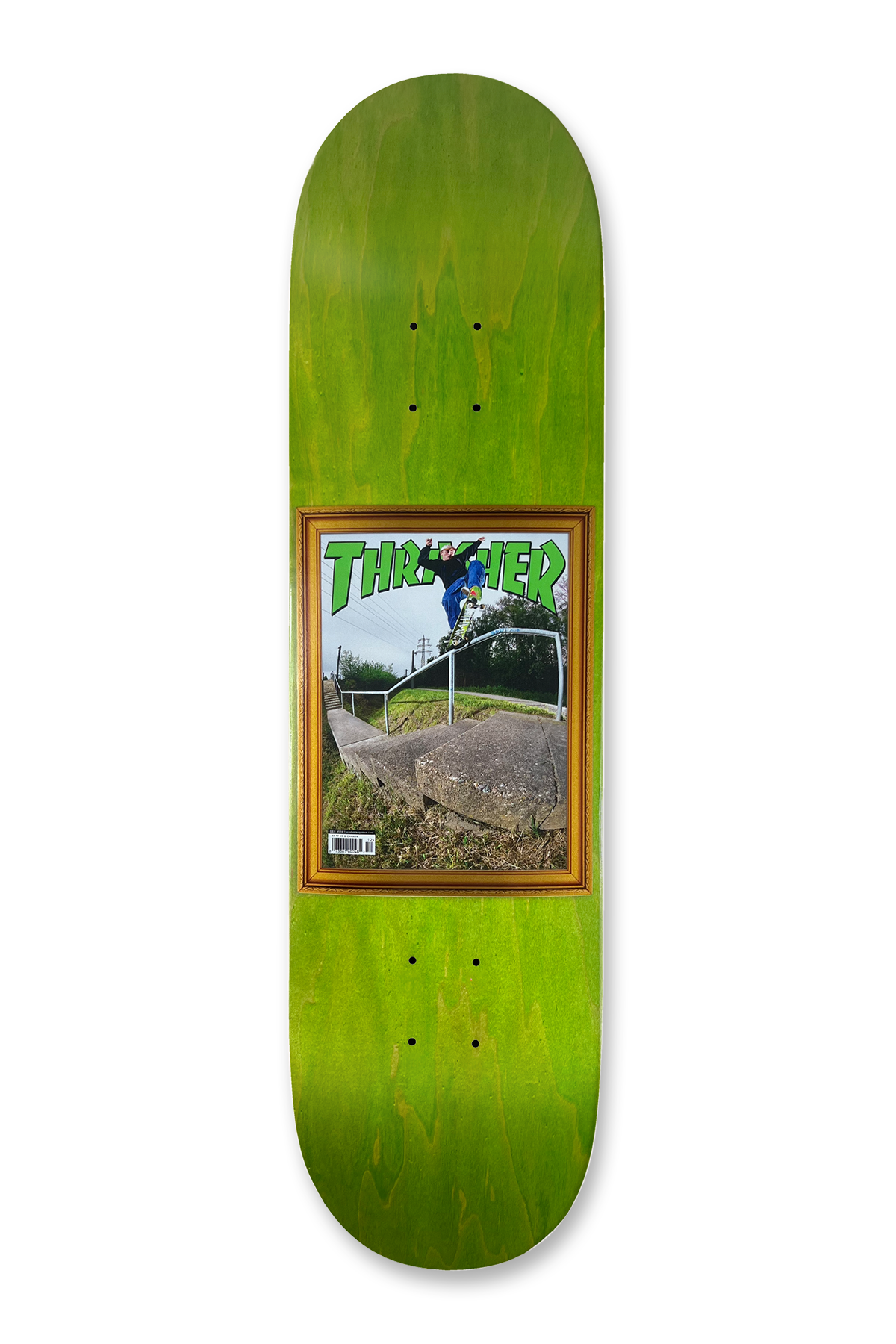 Deathwish Foy Commemorative Hammer 8.5 skateboard deck: A framed Thrasher magazine cover showing a skater in mid-air over a handrail beside a stone ledge, with a barcode on the cover. The frame is gold-brown on a green stained deck.