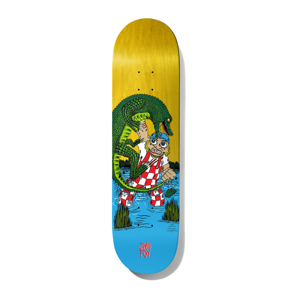 Deathwish Foy Gator Attack 8.25 skateboard deck: Cartoon of a wide-eyed man in a red-checked overalls and blue cap being attacked by a large green alligator while standing in a swamp with reeds. Yellow-stained top and blue water at the tail, rider name in red.