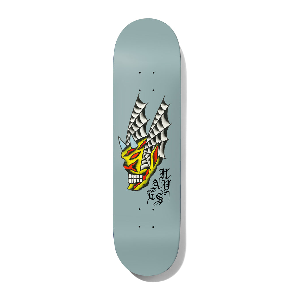 Deathwish Hayes Seven Trumpets 8.5 skateboard deck: Traditional tattoo-style yellow and red demon skull with blue horns and spider-web wings, on a pale grey-blue deck. HAYES in black gothic lettering running down beside it.