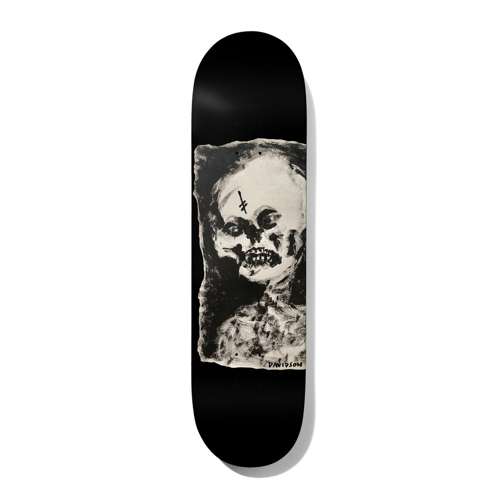 Deathwish Julian Expired 8.38 skateboard deck: Rough, painterly black-and-cream portrait of a ghoulish skull-faced figure with an inverted cross on the forehead, set in a ragged-edged panel on a black deck. Artist-style surname signed at the lower right.