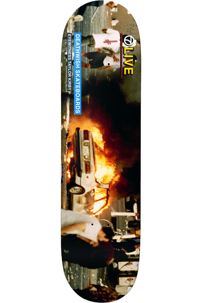 Deathwish Kirby Riots 8.3875 skateboard deck: A full-bleed photograph of a burning car on a street, with figures running past it. A blue label reads Deathwish Skateboards Eyewitness Taylor Kirby, and a yellow and black LIVE logo sits at the top.