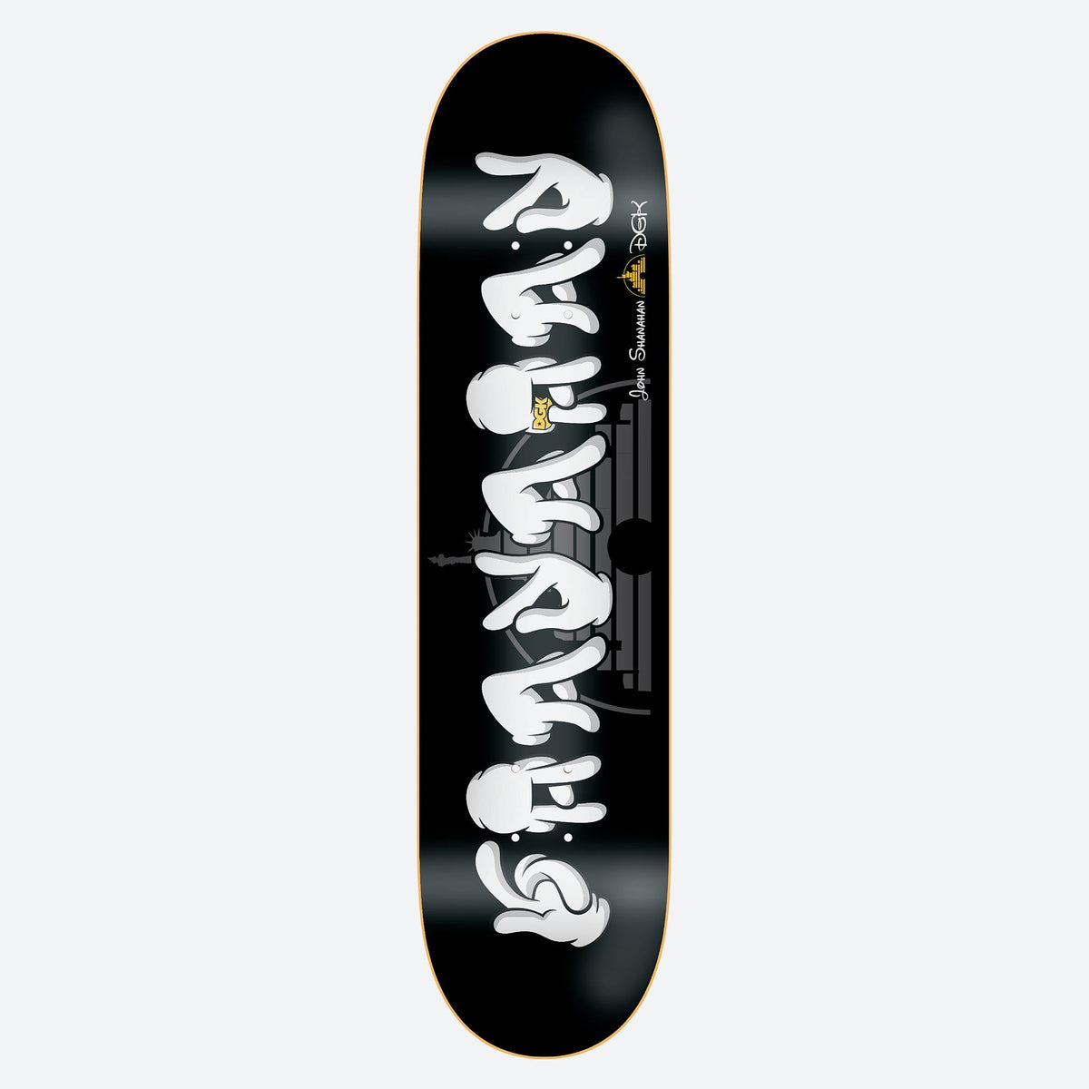 DGK All Night Shanahan 7.9 skateboard deck: White cartoon-gloved hands form a vertical stack of graffiti-style lettering on a black deck. A small silhouette skyline with the Statue of Liberty sits behind the lettering, with the rider's name and DGK logo beside it.