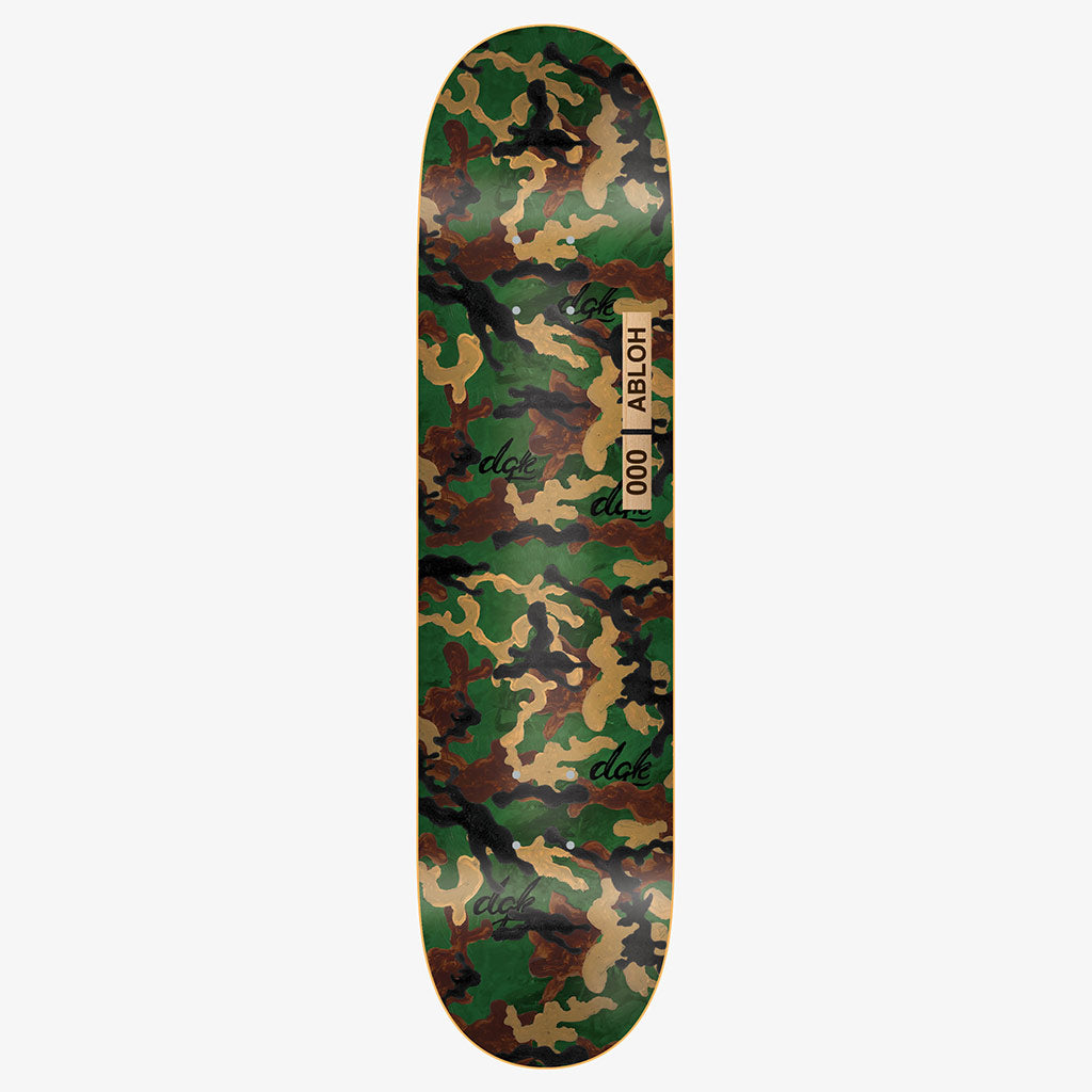 DGK Williams x Abloh skateboard deck: Green, tan and brown woodland camouflage pattern across the whole deck, repeated with small black DGK script tags. A tan label near the middle reads 000 and Abloh.