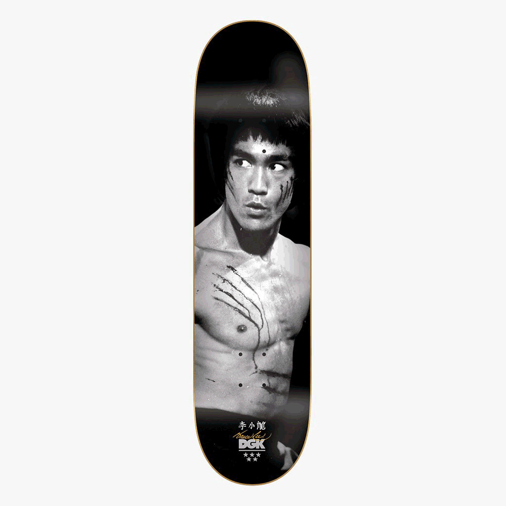 DGK x Bruce Lee Golden Dragon Lenticular skateboard deck: Black and white photograph of a shirtless martial artist with claw scratches across his chest and cheek, glancing to the side against a black background. Chinese characters, a signature and the brand logo sit at the bottom.