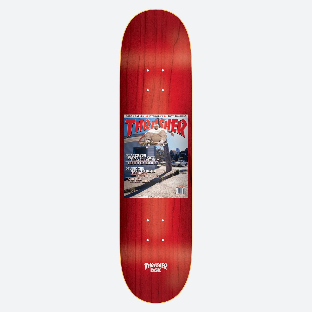 DGK x Thrasher McBride 8.25 skateboard deck: Red-stained deck with a reproduction of a Thrasher magazine cover in the centre, showing a skater grinding a ledge outside a building. Cover lines list places and music. Thrasher and DGK logo at the tail.
