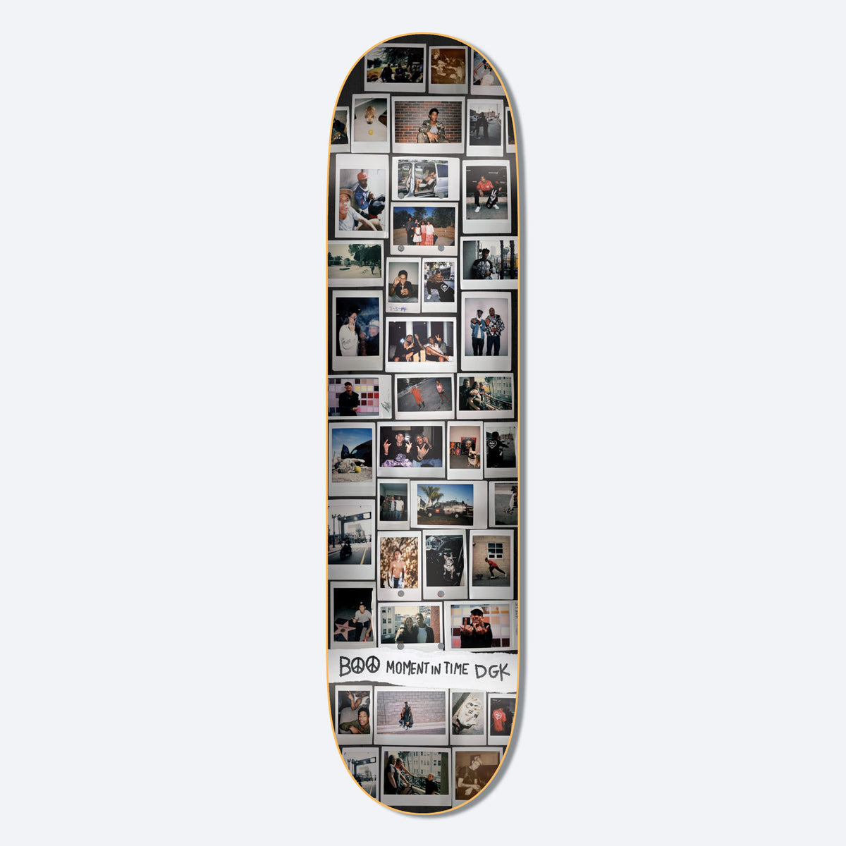 DGK Moments Boo 8.25 skateboard deck: A dense grid of instant-film snapshots covering the whole deck, showing people, street scenes and skating in varied colours. A torn white strip near the bottom carries the hand-drawn caption with a peace sign.