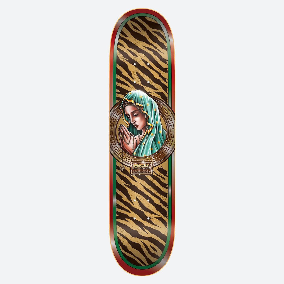 DGK Santa De Oro Fagundes 8.25 skateboard deck: A praying Madonna in a teal veil with gold stars is framed in a circular Greek key medallion, over a tiger-stripe pattern in tan and brown with red and green borders. A small gold DGK plaque sits below.