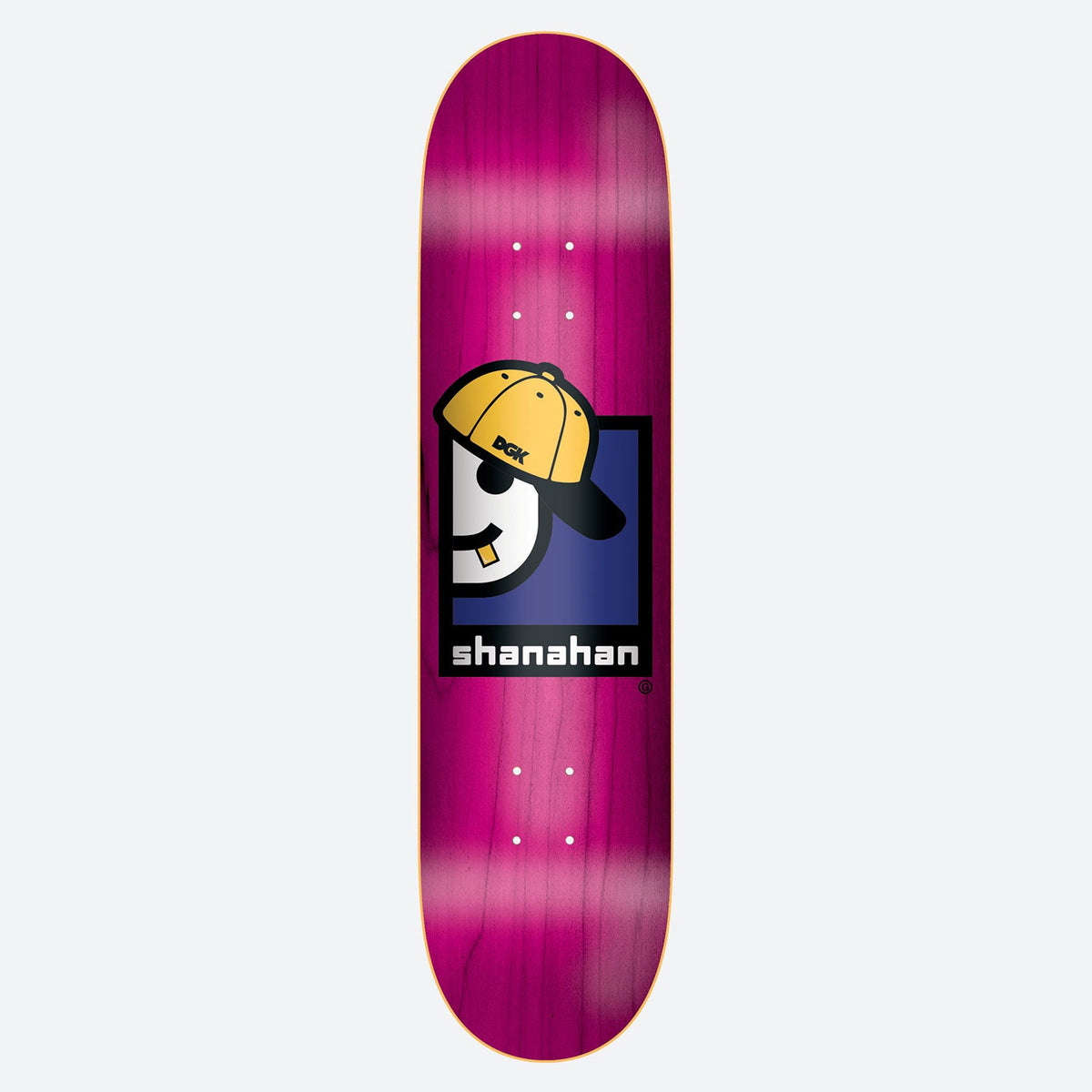 DGK Thrift Shanahan skateboard deck: A cartoon character with a yellow backwards DGK cap, sunglasses and a gold tooth sits within a navy and black square, above the rider's name in blocky white text. Pink stained deck.