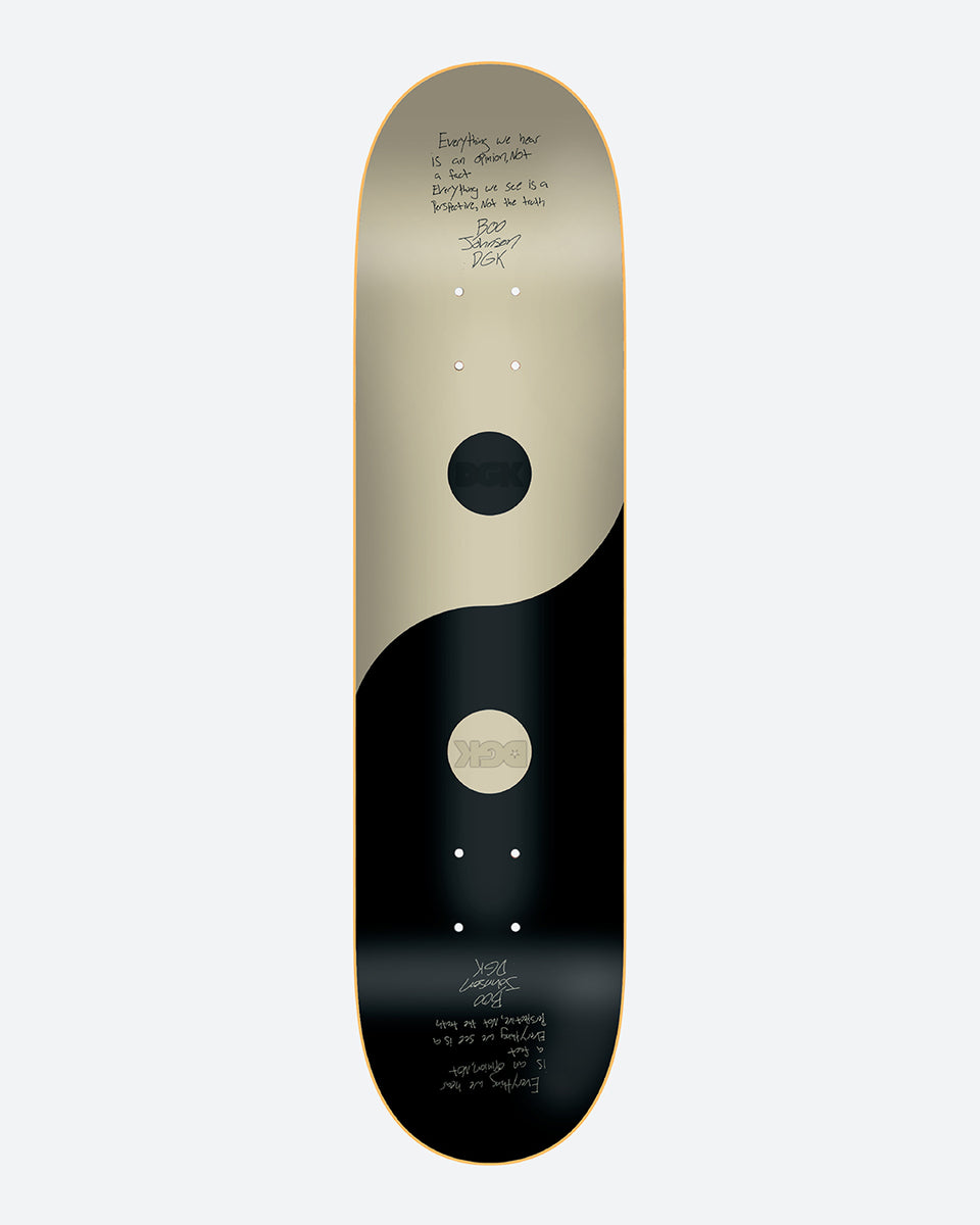 DGK Unity Boo 8.25 skateboard deck: Yin and yang split in cream and black, each half holding a circle of the opposite colour carrying a DGK mark, with handwritten text at both ends of the deck.