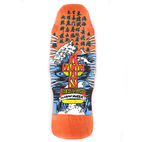 Dogtown Aaron Murray (Made in USA) skateboard deck: Old-school shaped deck with a Dogtown cross logo in red and yellow standing in a stormy blue ocean with white crashing waves, below columns of green Japanese-style characters, on an orange background. Rider name on the cross base.