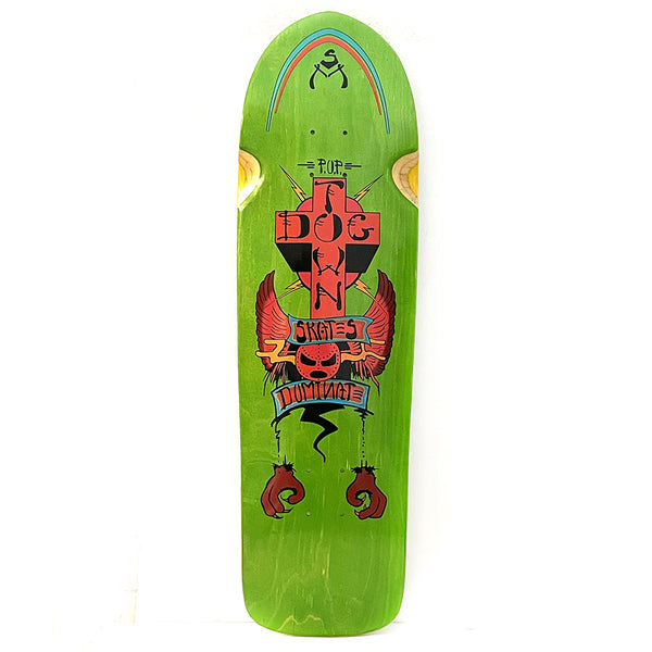 Dogtown Dominate x skateboard deck: A red Dogtown cross with winged skull, banners reading Skates and Dominate, and a pair of red clawed hands hanging below, on a green stained old-school pool shape. Rainbow arch and logo at the top.