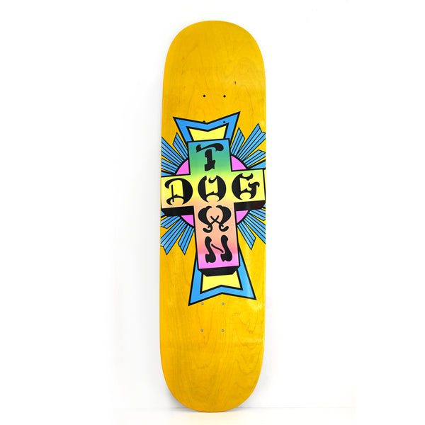Dogtown Neon Cross Street skateboard deck: Dogtown cross logo with black gothic lettering on a pastel gradient from yellow through green to pink, over a pink circle and blue rays, on a yellow-stained deck.
