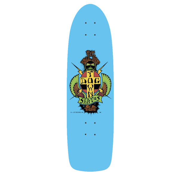Dogtown PC Tail Tap OG 70s Rider x skateboard deck: Dogtown crest with a yellow cross over a shield, green wings, lightning bolts and a green Skates banner, with a skull-headed figure above and a scrawled signature below, on a plain light blue deck.