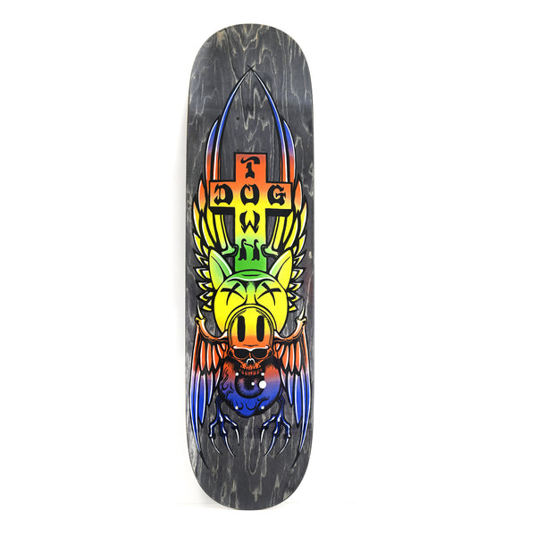 Dogtown Pig Skull Street skateboard deck: Winged pig head with crossed-out eyes below a Dogtown cross, over a skull and a blue eyeball with clawed wings. Everything is in a rainbow gradient on a grey-stained deck.