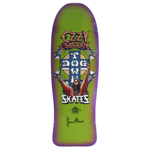 Dogtown Limited Dogtown Ozzy Osbourne - x - Gecko Green / Lavender / Purple Fade skateboard deck: Old-school shaped deck with a heavy-metal-style portrait of a long-haired figure with arms raised in front of the Dogtown cross, flanked by bat wings and chains. Ozzy Osbourne logo above, Skates below, with a signature at the bottom.