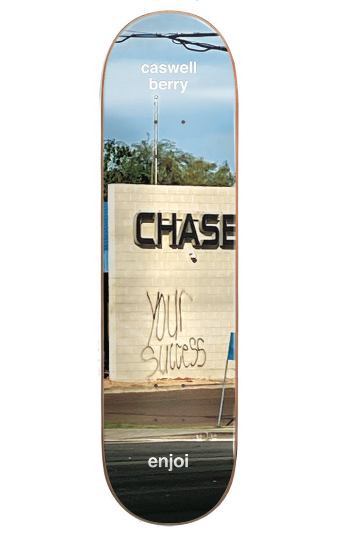 Enjoi Berry Tweaker R7 8.0 & 8.5 skateboard deck: Photograph of a Chase bank sign on a brick wall with 'your success' spray-painted below it, power lines and sky above. Caswell Berry name at the nose and enjoi at the tail.