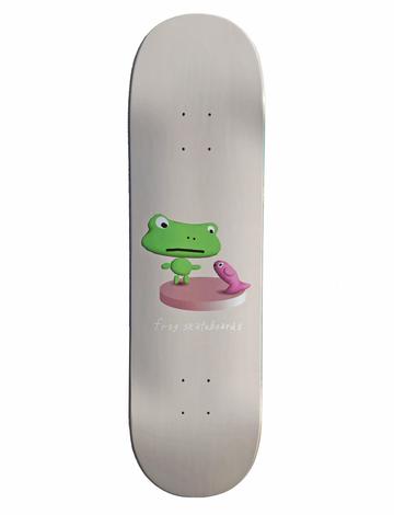 Frog Annoying Fish 8.6 skateboard deck: Pale grey deck with a small 3D-rendered cartoon green frog standing on a pink round platform, facing a small pink fish. Frog Skateboards is written in small white handwriting beneath.