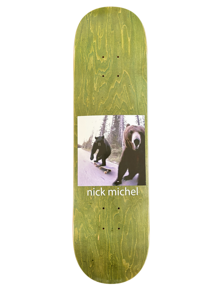 Frog Bears (Nick Michel) skateboard deck: A square photograph of two bears on a forest road, one riding a skateboard while a second runs up close to the camera, set on a green-stained wood deck. 'nick michel' is printed beneath in white.