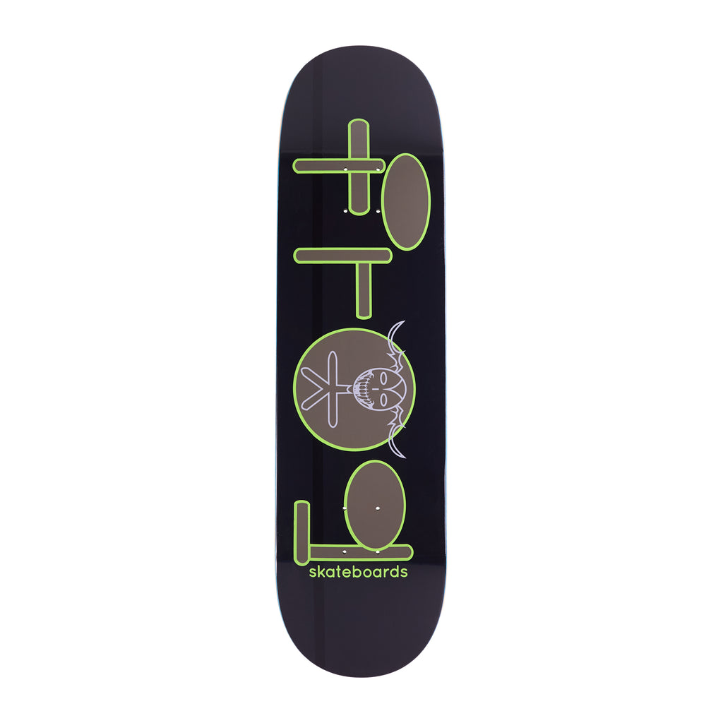 Frog Skoom Logo skateboard deck: Frog logo built from green-outlined brown ovals and bars with a pale skull-faced character with horns in the circle, on a dark purple-black deck. A green skateboards caption sits near the tail.