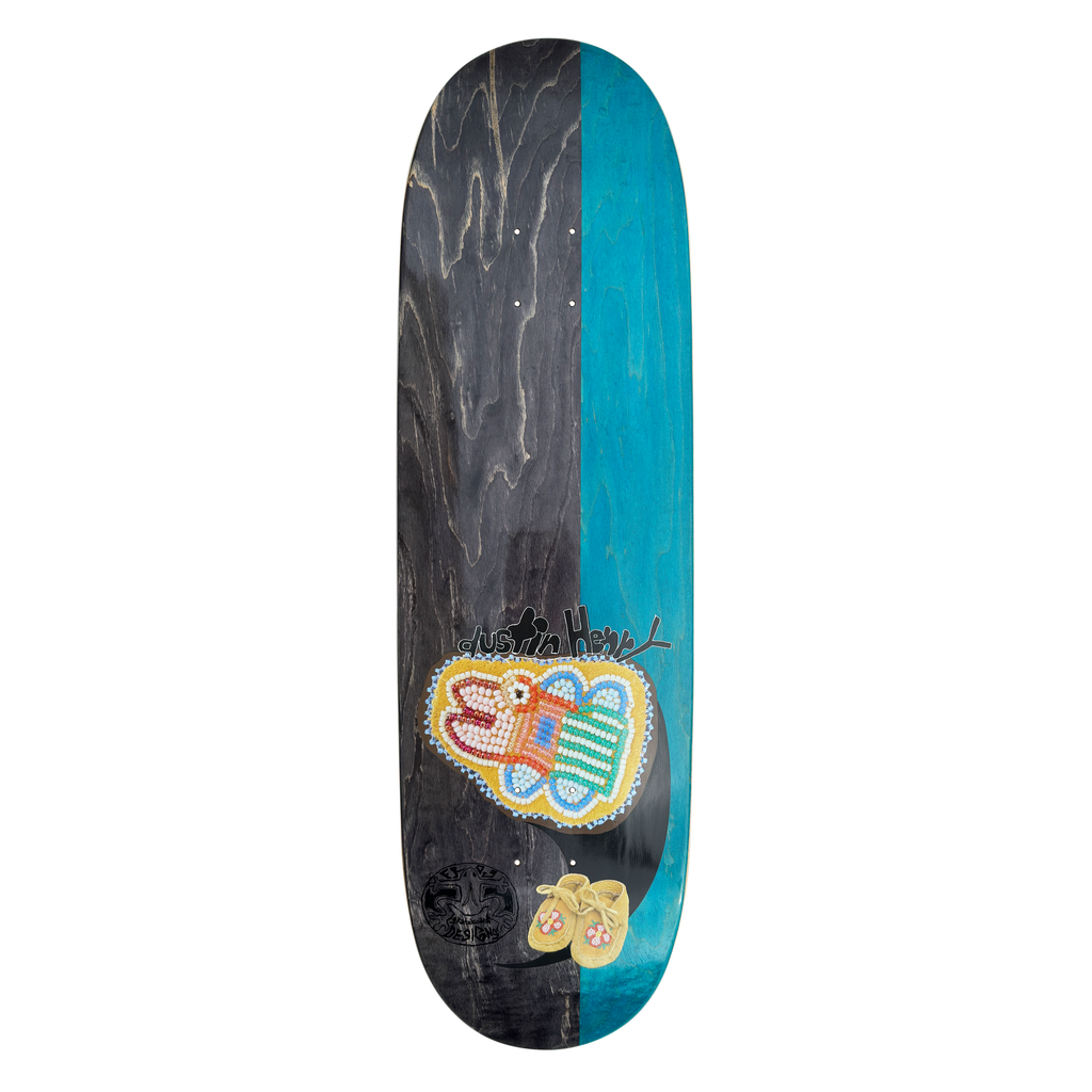 Frog Łuk Tsul (Dustin Henry) skateboard deck: Wood-stained deck split black on the left and teal on the right, with a beaded floral-style patch in yellow, pink and green, a pair of beaded moccasins, a handwritten rider name and a small round emblem.