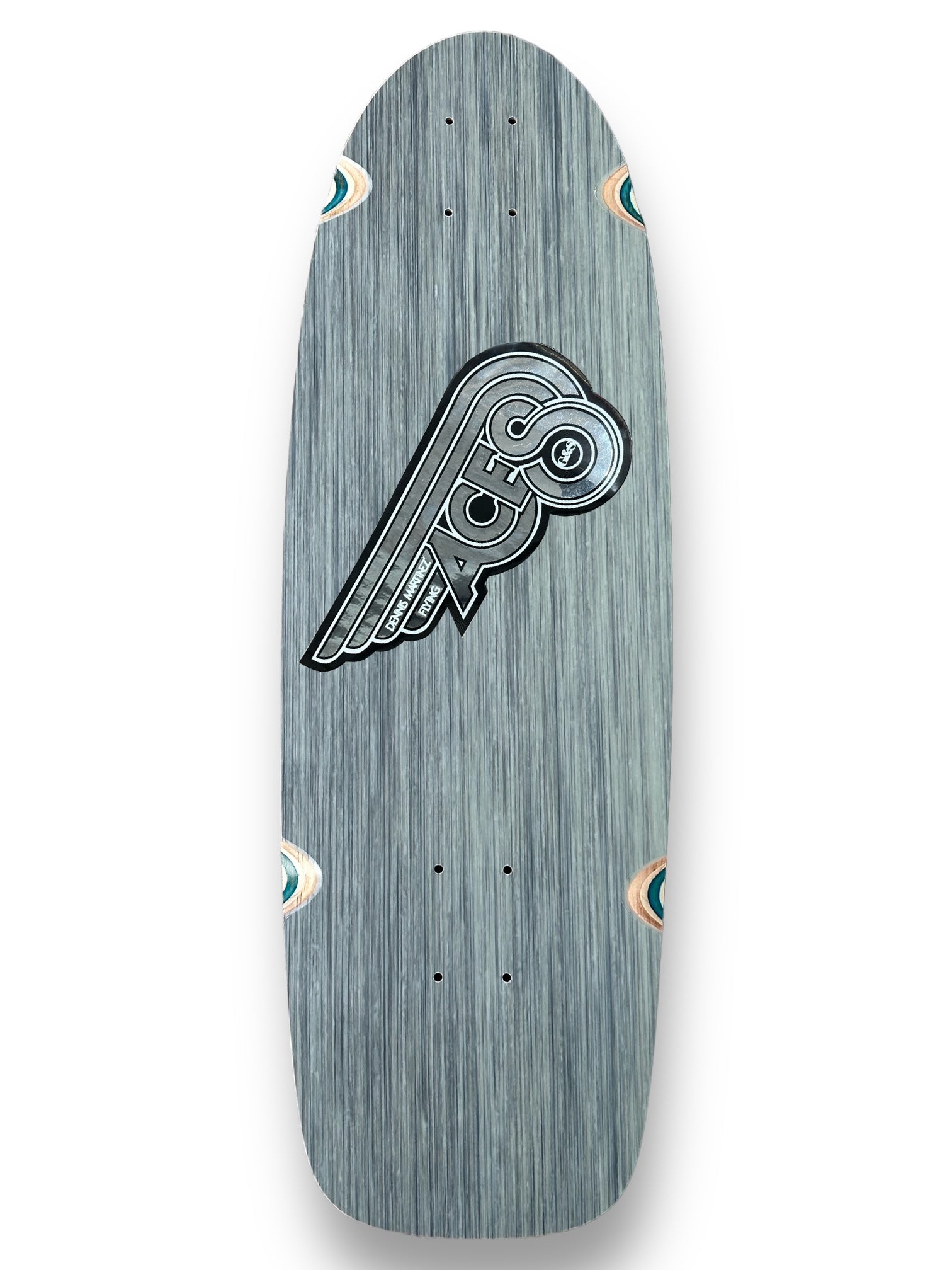 G&S Fibreflex Dennis Martinezs Flying Aces - Multiple Colors skateboard deck: A chrome and grey winged emblem with the word Aces in an old-school badge design on a grey fibreglass-look deck with a retro shape and teal-ringed wheel cut-outs.
