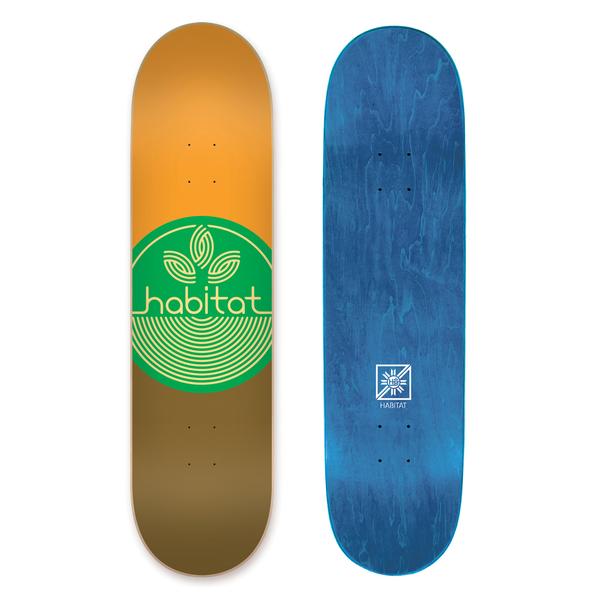 Habitat Leaf Dot Md skateboard deck: A green circle with a pale outline leaf-and-rings logo and the brand name across it, over a deck split orange above and brown below. The blue-stained underside is also shown.