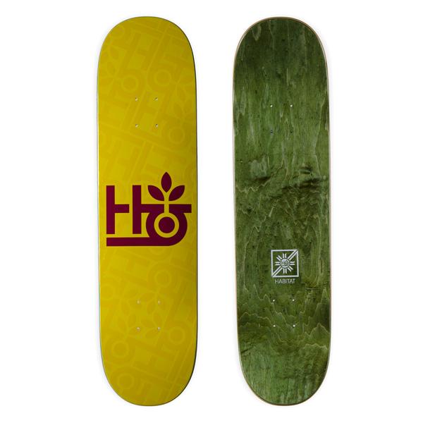 Habitat Monopod Embossed skateboard deck: Mustard yellow deck with a maroon Habitat logo of stacked H and G shapes topped by a sprouting leaf, over a faint embossed repeat of the same logo. Green-stained underside with a small emblem shown beside it.