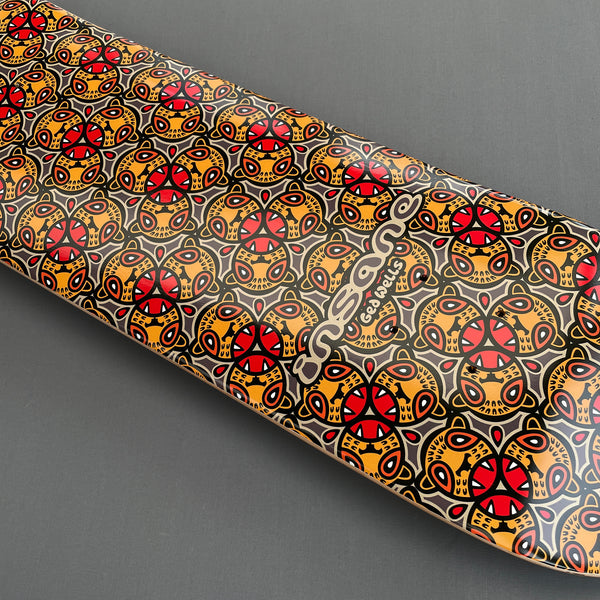 Insane Leopards skateboard deck: All-over repeating pattern of stylised leopard heads in orange, red and yellow with black outlines on a grey ground. Insane logo and 'Ged Wells' in cream outline lettering across the middle.