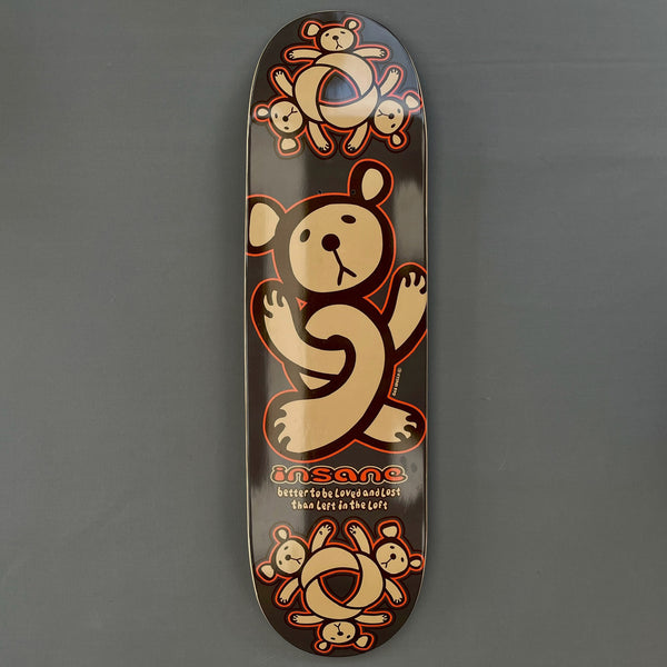 Insane Twisted Teddy skateboard deck: A large tan teddy bear with orange outline, its legs twisted into a knot, with clusters of small bears around knotted rings at top and bottom on a dark brown deck.
