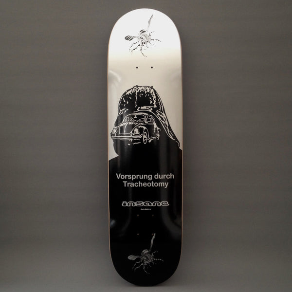 Insane Vorsprung Durch Tracheotomy skateboard deck: Silver-to-black deck showing a Volkswagen Beetle inside the outline of a dark helmeted figure, with two flies at the top and bottom. The title and the brand logo are printed in grey in the lower half.