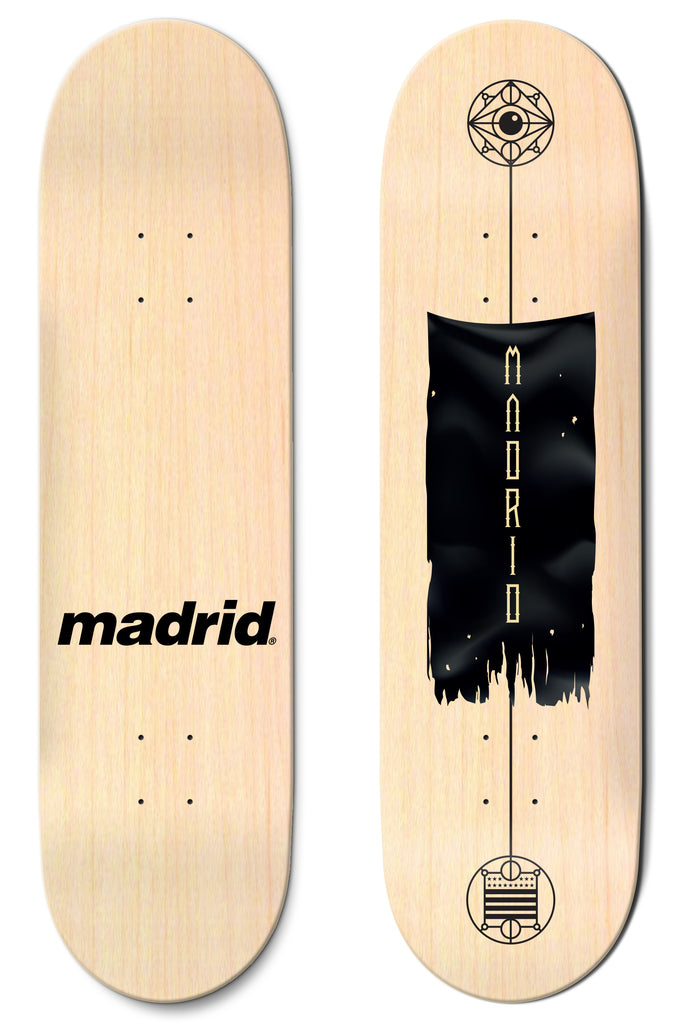 Madrid Battle Flag 8 skateboard deck: Natural wood deck with a torn black banner with vertical gold lettering, between two geometric emblems linked by a thin line, one topped with an eye. The other deck shows only the Madrid logo in black.