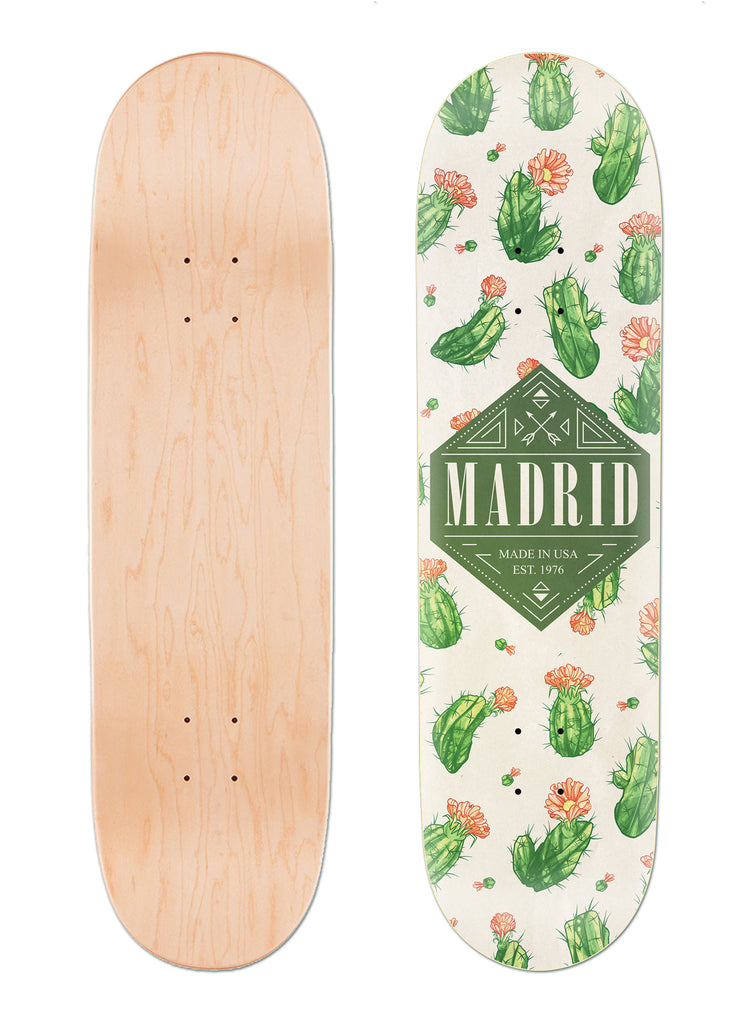 Madrid Cacti 8 skateboard deck: Cream deck covered in green cacti with orange-pink flowers, with a dark green diamond badge reading Madrid, Made in USA, Est. 1976 in the centre. Underside is plain natural maple.
