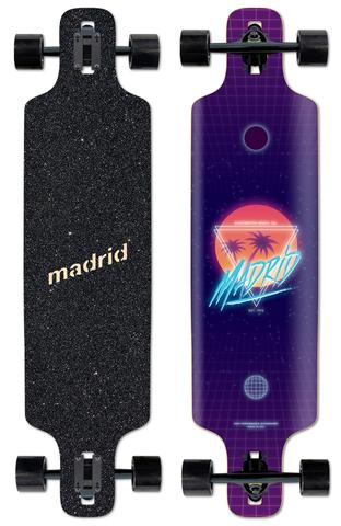 Madrid Dtf 39 skateboard deck: Purple longboard with a retro synthwave design: a sunset circle with palm trees in a triangle and neon Madrid script, over a perspective grid. Black griptape side shows the Madrid name. Shown with trucks and black wheels.