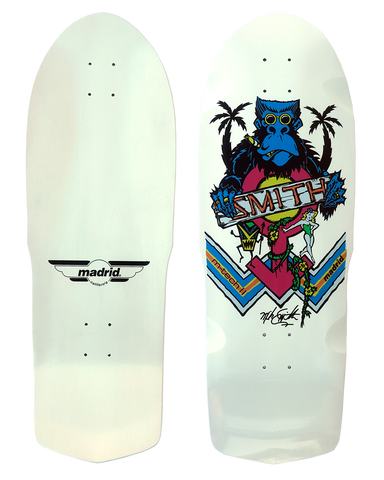 Madrid Retro Mike Smith Ape skateboard deck: Old-school shaped white deck showing a blue gorilla with round glasses and a cigar between palm trees, holding a banner reading 'SMITH', with a pink circle, a small green pin-up girl, a tiki figure and blue striped chevrons. Plain white bottom with Madrid winged logo.