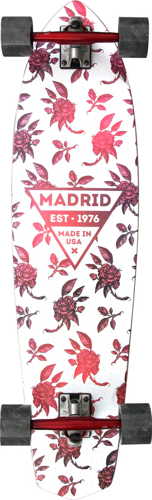 Madrid Dude 37.25 skateboard deck: White cruiser with an all-over pattern of red and pink roses and leaves, with a central inverted triangle logo reading Madrid, established 1976, made in USA.