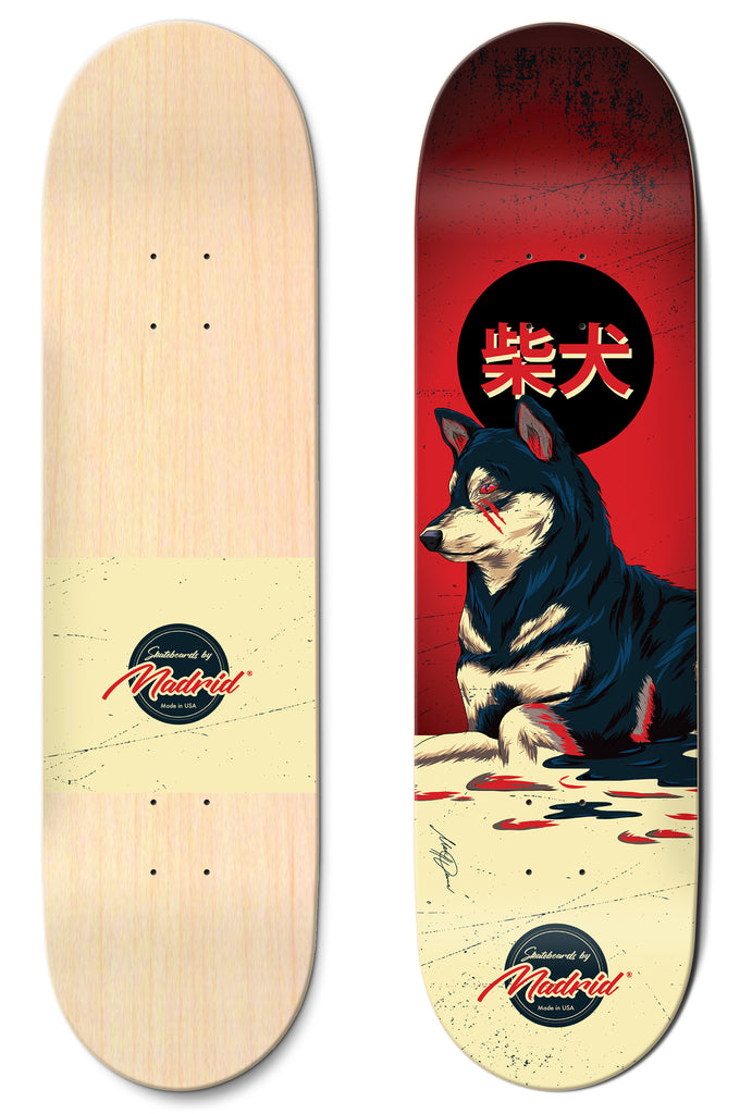 Madrid Shiba 8 skateboard deck: Illustration of a seated Shiba Inu with red markings against a red sky and a black sun bearing Japanese characters, on a cream ground with red splashes. Madrid badge logo near the tail; plain natural underside shown alongside.