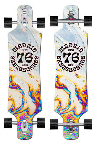 Madrid Spade 39 skateboard deck: A drop-through longboard shown from top and underneath, with a swirling oil-slick marbled pattern in white, blue, orange and purple. A round black Madrid Skateboards Est 76 USA logo sits in the middle.