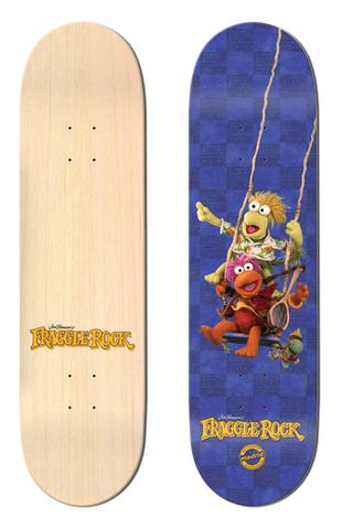 Madrid x Fraggle Rock Swing 8 skateboard deck: Two Fraggle Rock puppet characters sit together on a rope swing against a blue checkerboard background, with a small character below. The Fraggle Rock logo sits at the bottom; the other deck is plain natural wood with a small logo.