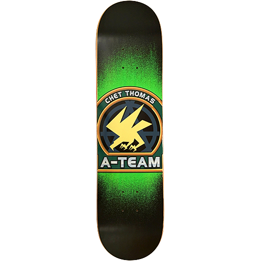 A-Team Chet Thomas Crest skateboard deck: Circular crest in green and gold with a yellow stylised bird of prey over a dark blue wheel emblem, on a black deck with a glowing green spray fade. Rider name curves round the top and A-TEAM sits on a silver banner below.