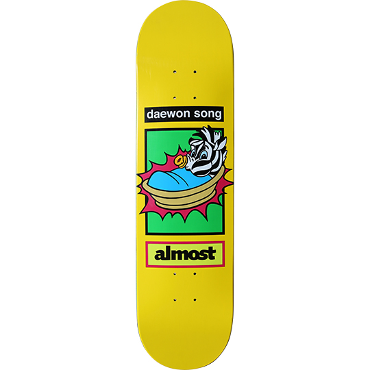 Almost Daewon Song Love Child skateboard deck: Yellow deck with a green boxed panel showing a cartoon zebra baby in a basket with a dummy, framed by a red starburst. Daewon Song name plate above and a yellow almost label below.