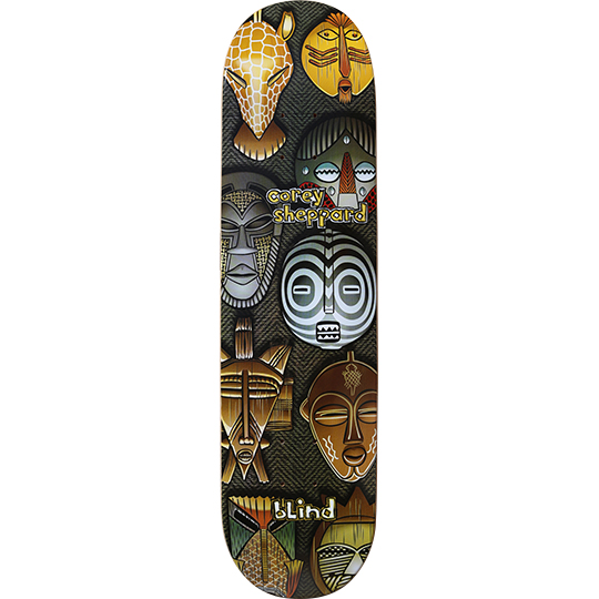 Blind Corey Sheppard Masks skateboard deck: Collection of African-style tribal masks and a giraffe head, painted in gold, grey, brown and white on a dark woven background. Rider name in yellow lettering and Blind logo at the bottom.