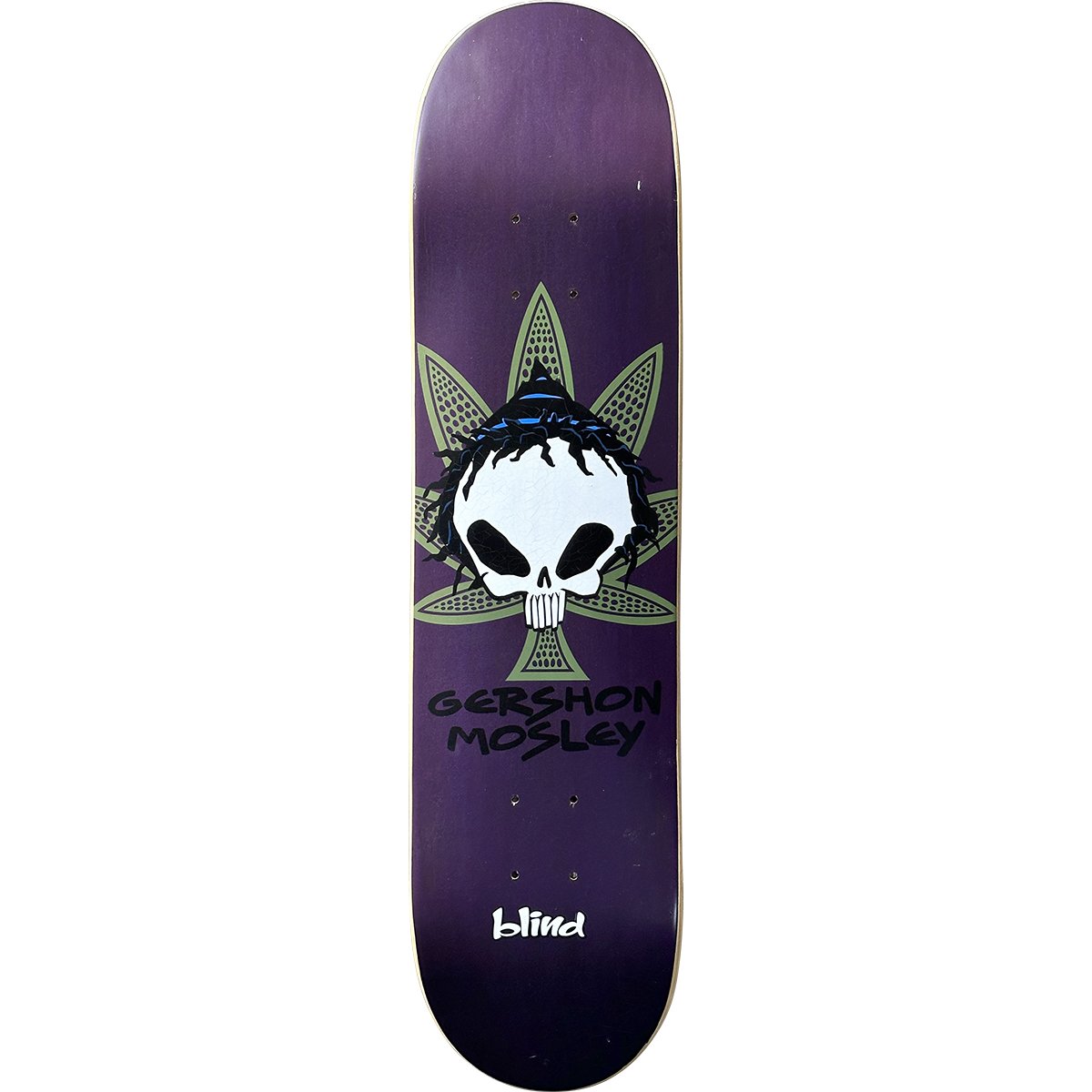 Blind Gershon Mosley Reaper Rasta Skull skateboard deck: Blind reaper skull with black dreadlocks and a blue band, set in front of a green cannabis leaf on a purple deck, with the rider's name beneath.