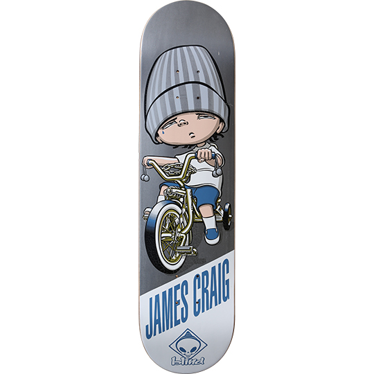 Blind James Craig Lowrida skateboard deck: A cartoon child in an oversized grey striped beanie, with sleepy eyes, rides a gold lowrider bicycle with stabilisers. The rider's name is printed in blue at the bottom with the Blind alien logo.