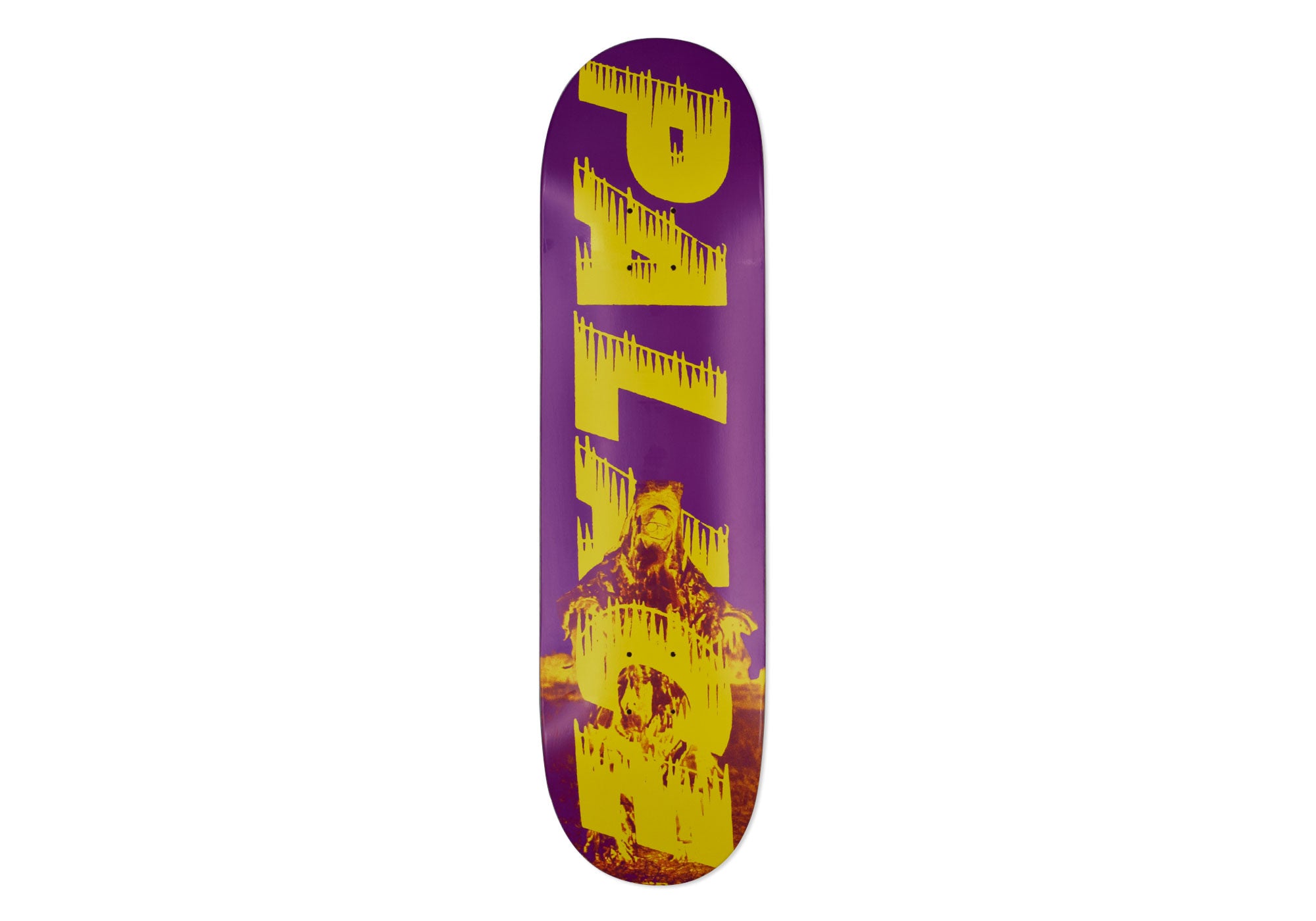 Palace Bankhead Purple 8.4 skateboard deck: Purple deck with large yellow Palace lettering with dripping edges running down its length, over a yellow-toned photograph of a figure in a fur-trimmed coat seated in front of a fire.