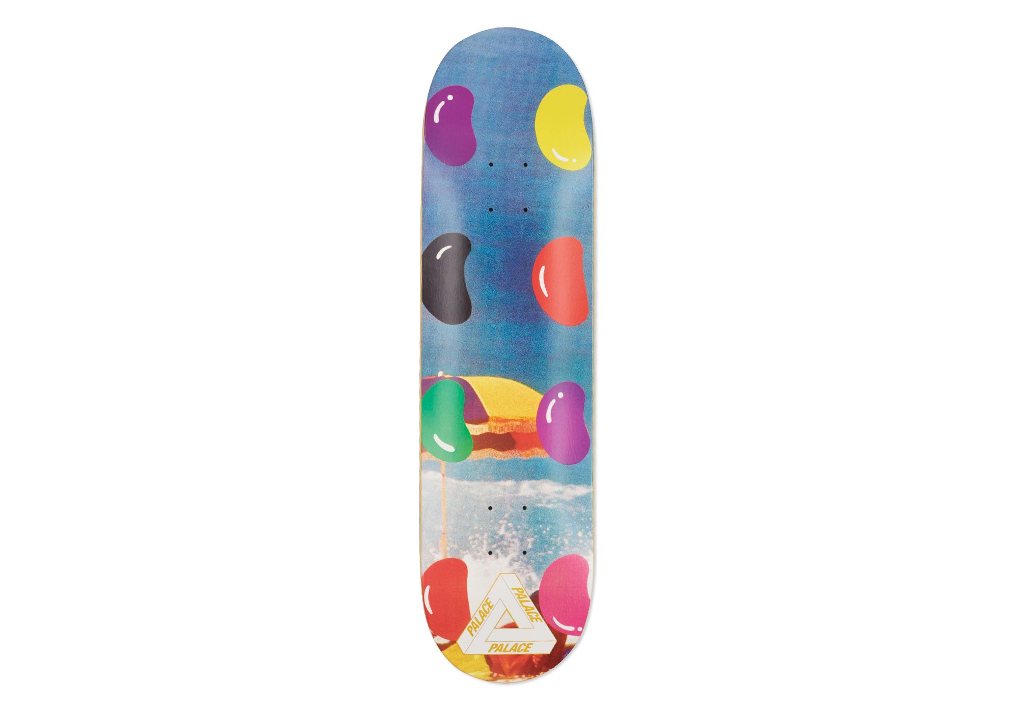 Palace Beans 8.2 skateboard deck: Large glossy jelly beans in purple, yellow, black, red, green and pink float over a photographic beach scene with a striped parasol and surf. The Palace tri-ferg logo is at the tail.