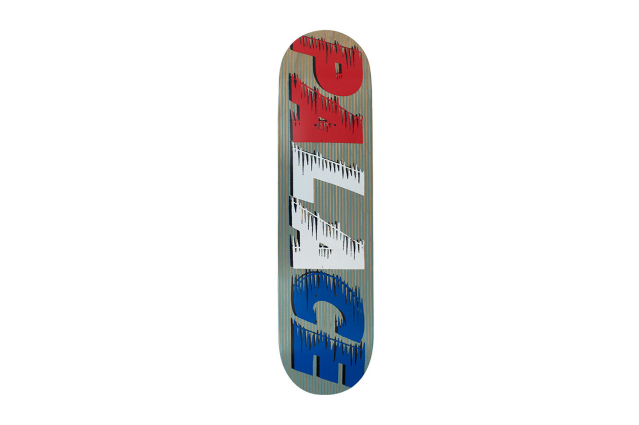 Palace Fast Grey Team Board skateboard deck: Grey ribbed-look deck with large Palace lettering set vertically, split into red, white and blue sections, each with dripping, speed-streak edges.