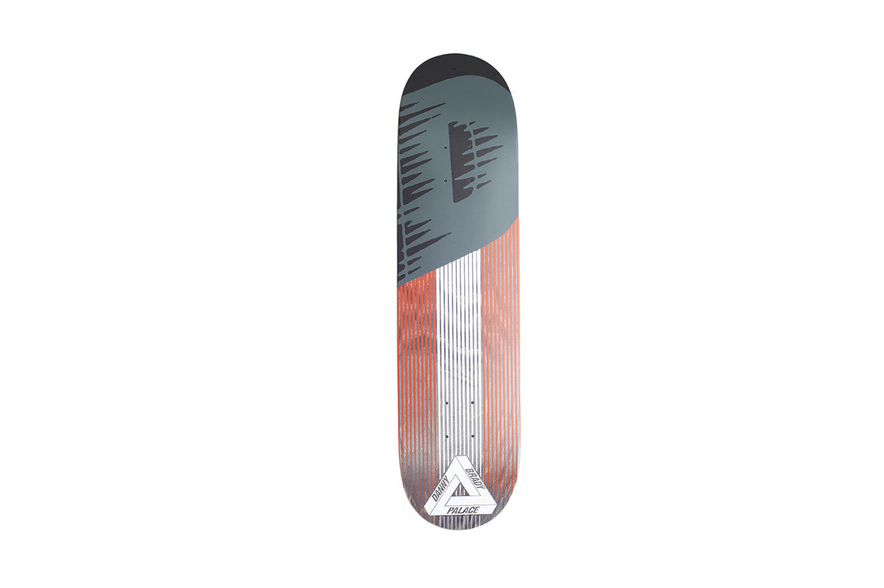 Palace Pro Linear Brady Board skateboard deck: A diagonal split design: the upper section is slate grey with black dripping brush marks, and the lower section has orange-red and white vertical stripes. A white Palace triangle logo with Danny Brady sits at the tail.