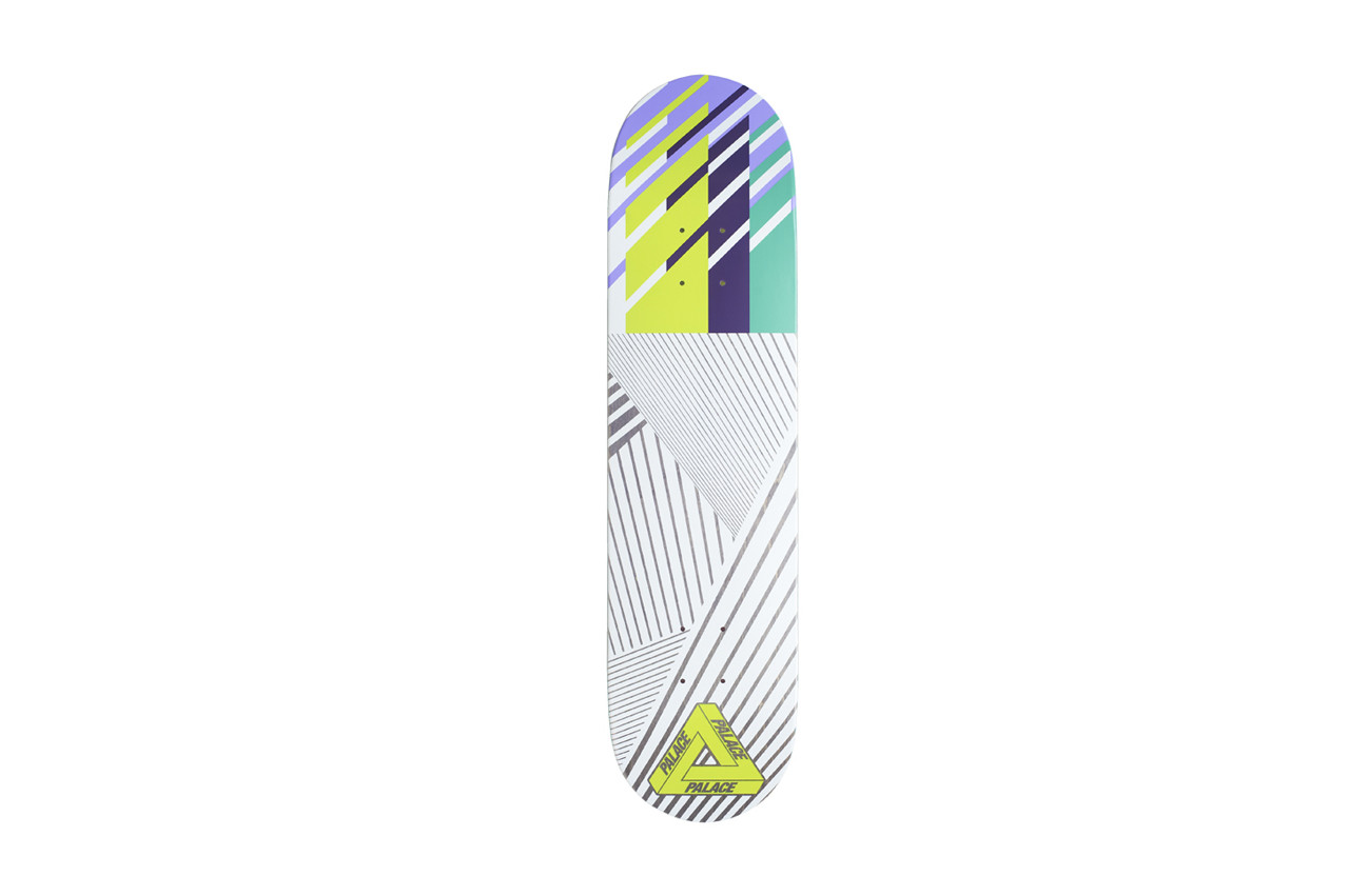 Palace Stunt Team One Board skateboard deck: White deck with grey diagonal line patterns forming a faint triangle, topped by purple, lime green, navy and mint diagonal stripes. A lime Palace tri-ferg logo sits at the tail.