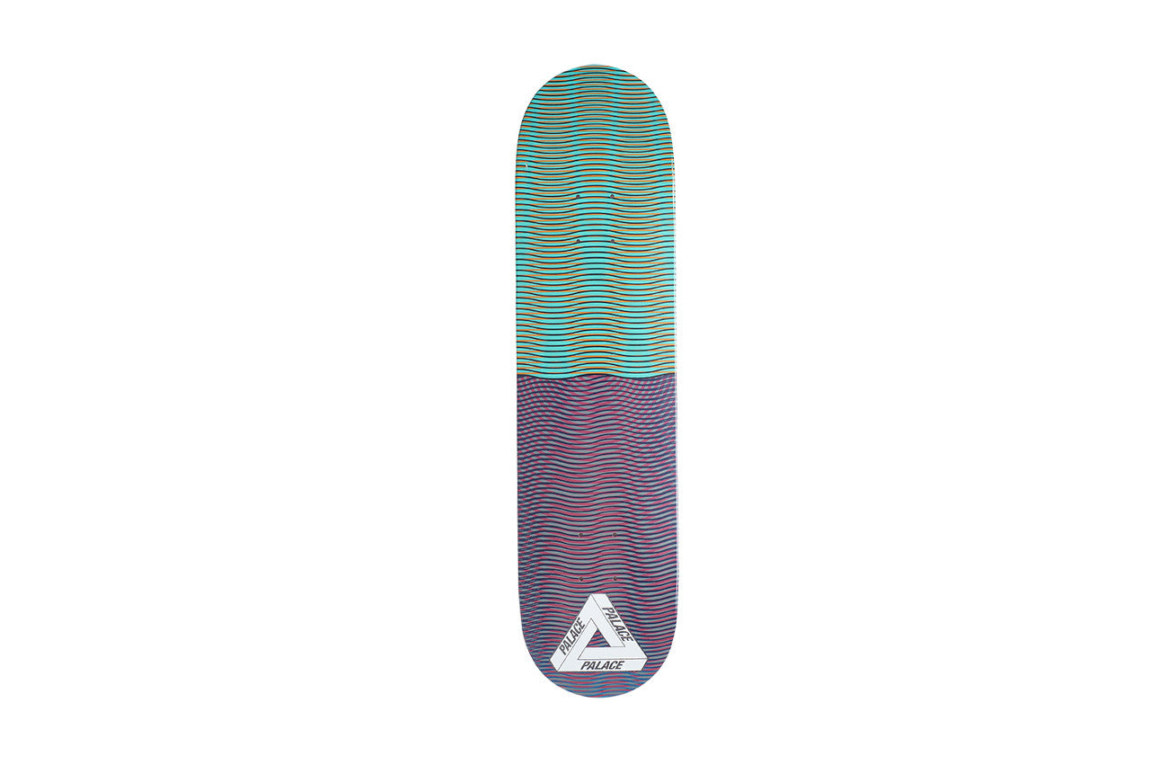 Palace Trippy Stick One Board skateboard deck: Top half of the deck is teal-green with wavy optical-illusion lines and the lower half purple with similar moiré waves. White Palace Tri-Ferg triangle logo at the tail.