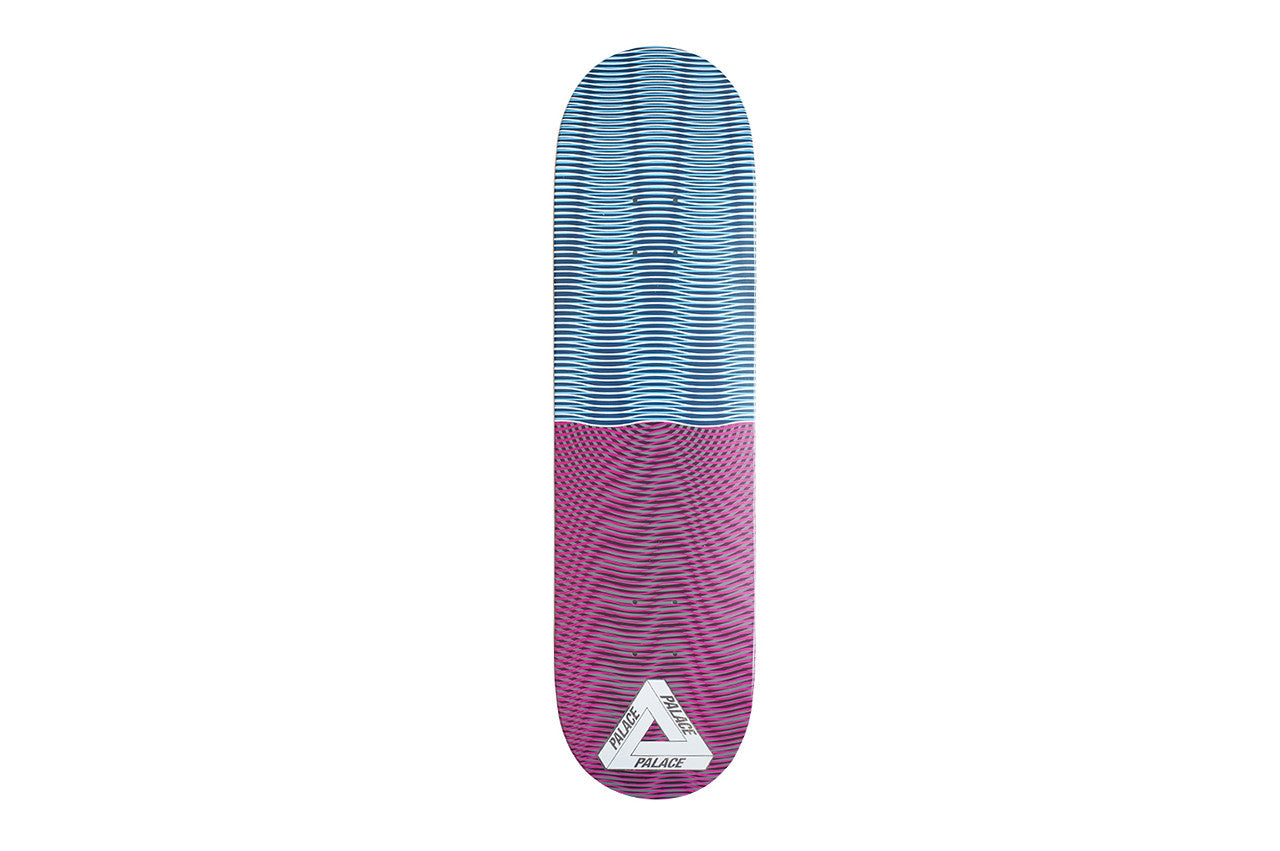 Palace Trippy Stick Two Board skateboard deck: Wavy, optical moire line patterns, blue in the upper half and magenta in the lower half, with a white Palace triangle logo near the tail.